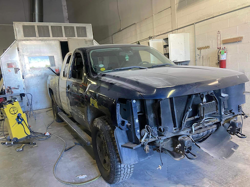 Blue truck with damaged paint