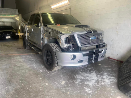 Silver truck with damaged paint