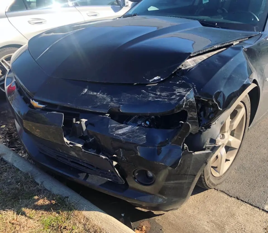 Mustang with broken front bumper, hood, and headlights